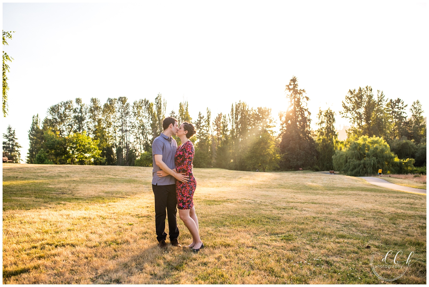 couple standing together in an open field at Juanita Bay Park