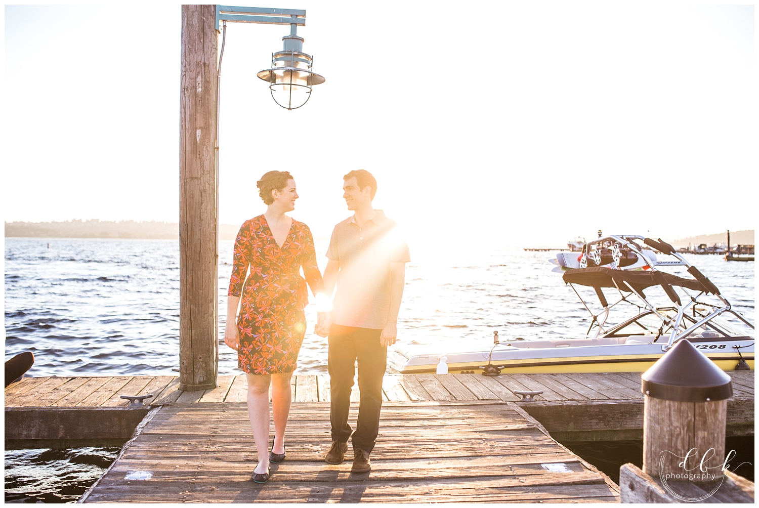 couple walking along the pier as the sun sets over the Kirkland Marina