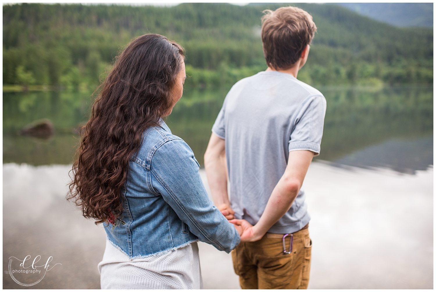 candid portrait of couple walking toward the water at Rattlesnake Lake in North Bend