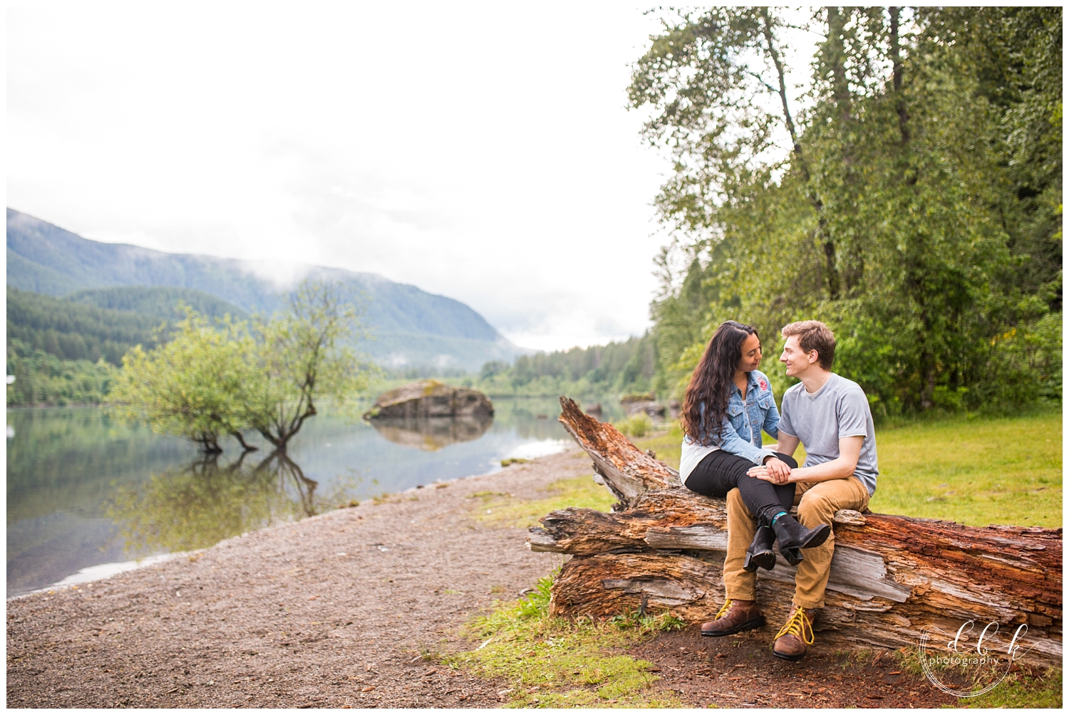 couple sitting on a log together at Rattlesnake Lake in North Bend, Washington