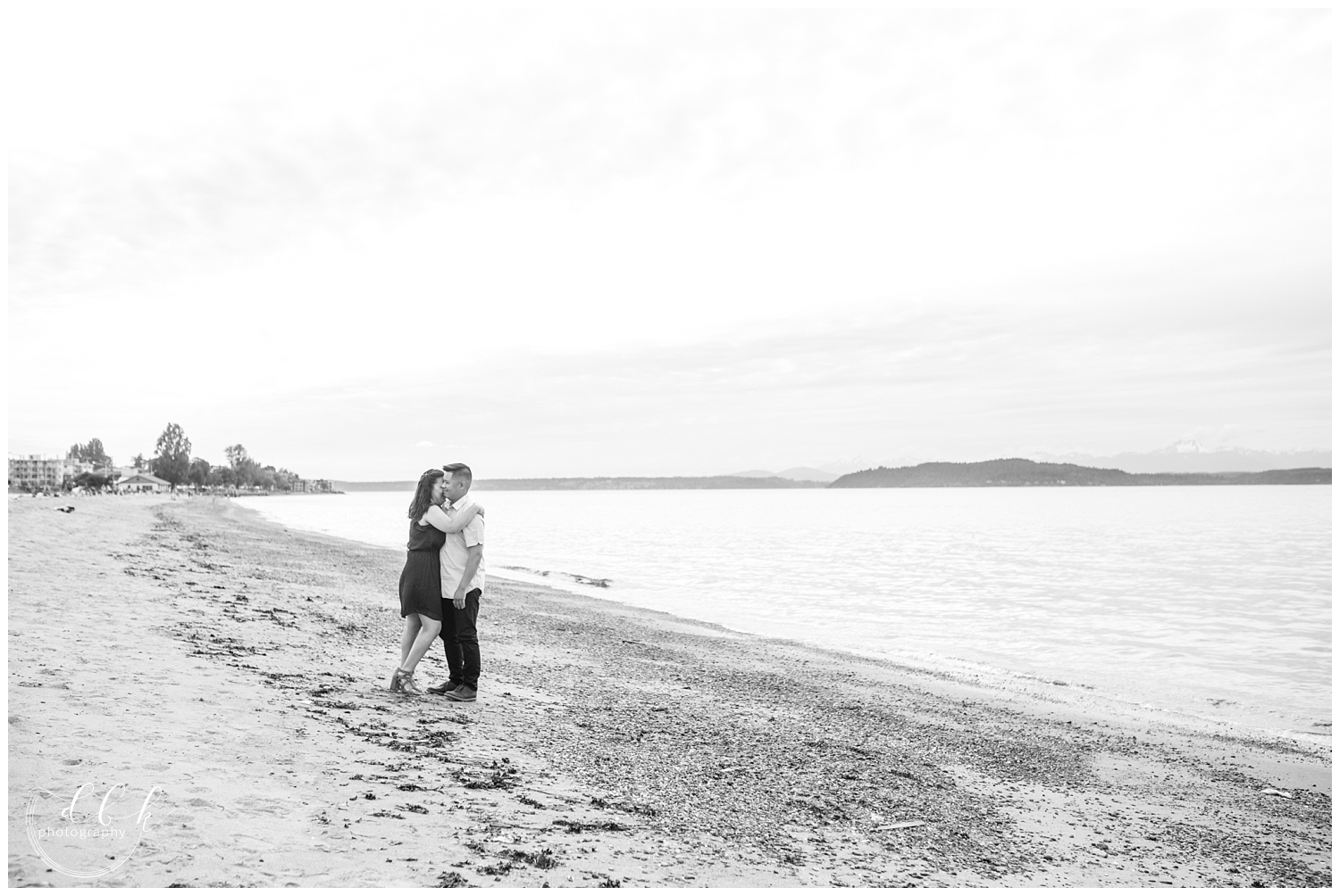 black and white picture of engaged couple on the beach in West Seattle