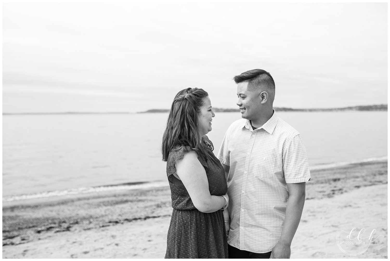 black and white engagement portrait on beach in West Seattle
