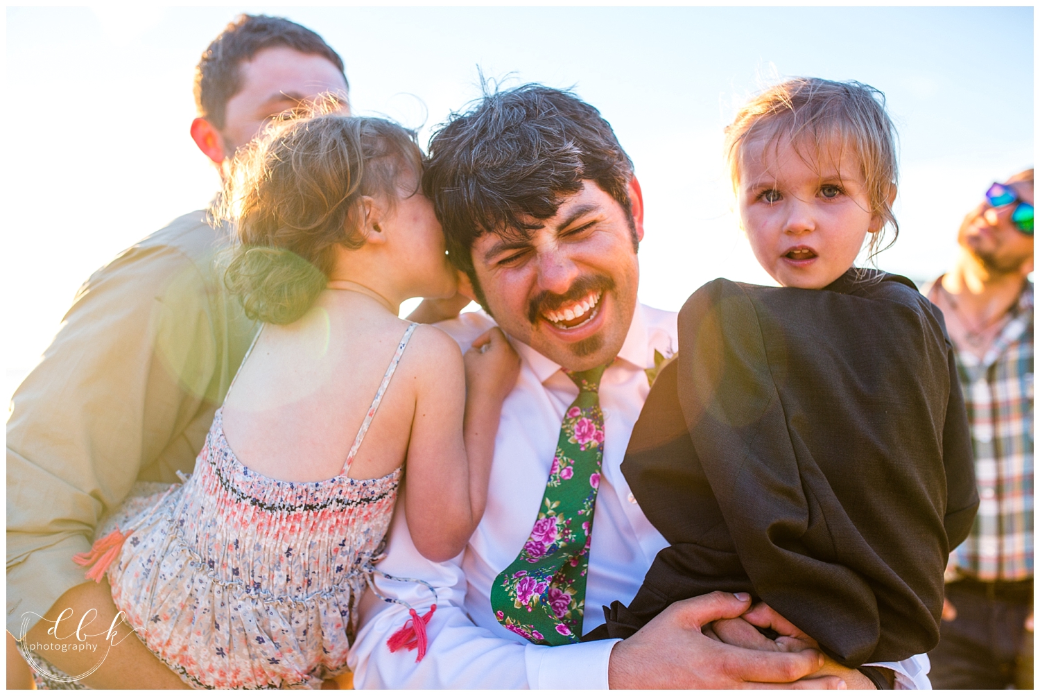 groom goofing around with little flower girls at Anacortes wedding in Washington Park