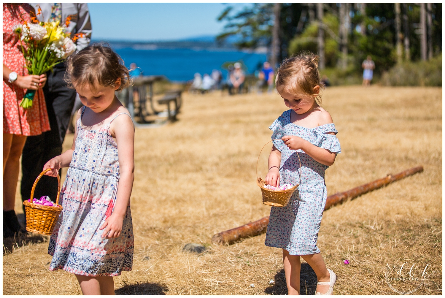 flower girls wearing flowered dresses tossing petals at ceremony in Anacortes, Washington