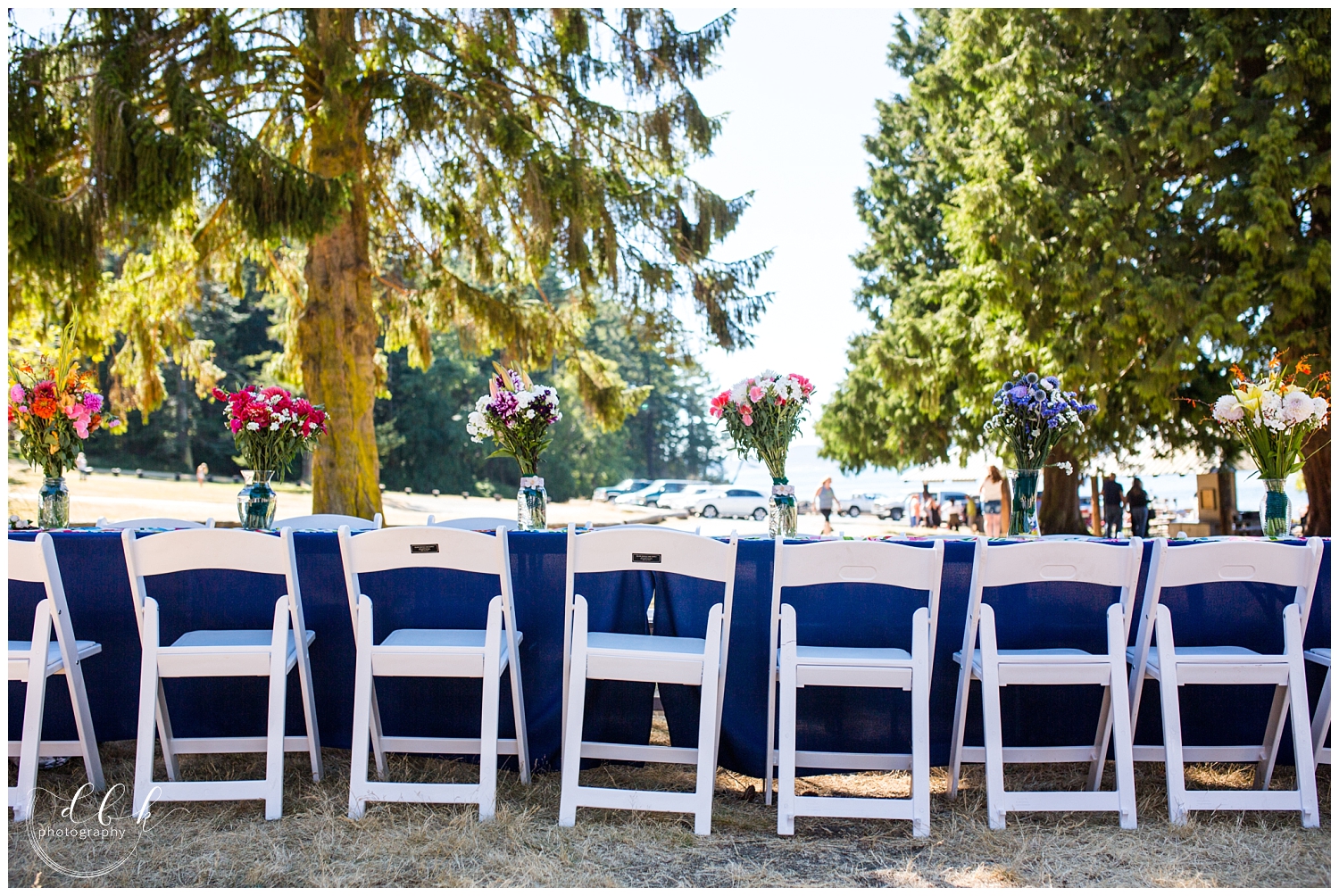 bridal party table set with wildflower bouquets at summer wedding at Washington Park in Anacortes, Washington