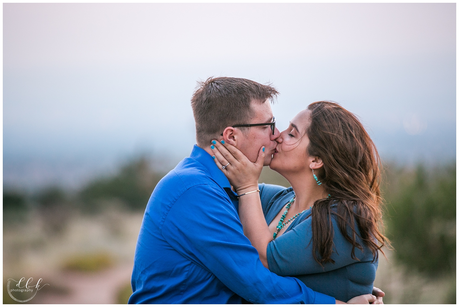 bride in turquoise jewelry kissing her future husband for engagement portraits in Albuquerque, New Mexico