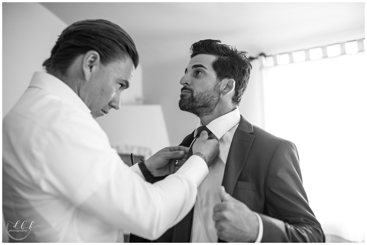 groom putting on his tie at Albuquerque wedding at Casa Rondena Winery