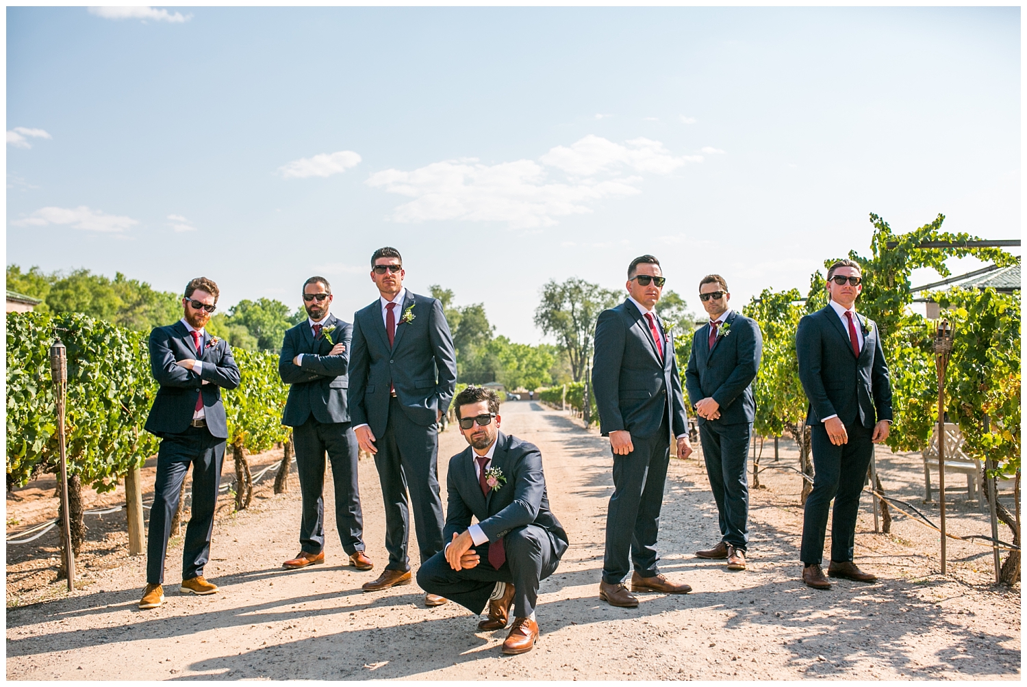 cool groomsmen pose with sunglasses at vineyard in Albuquerque New Mexico