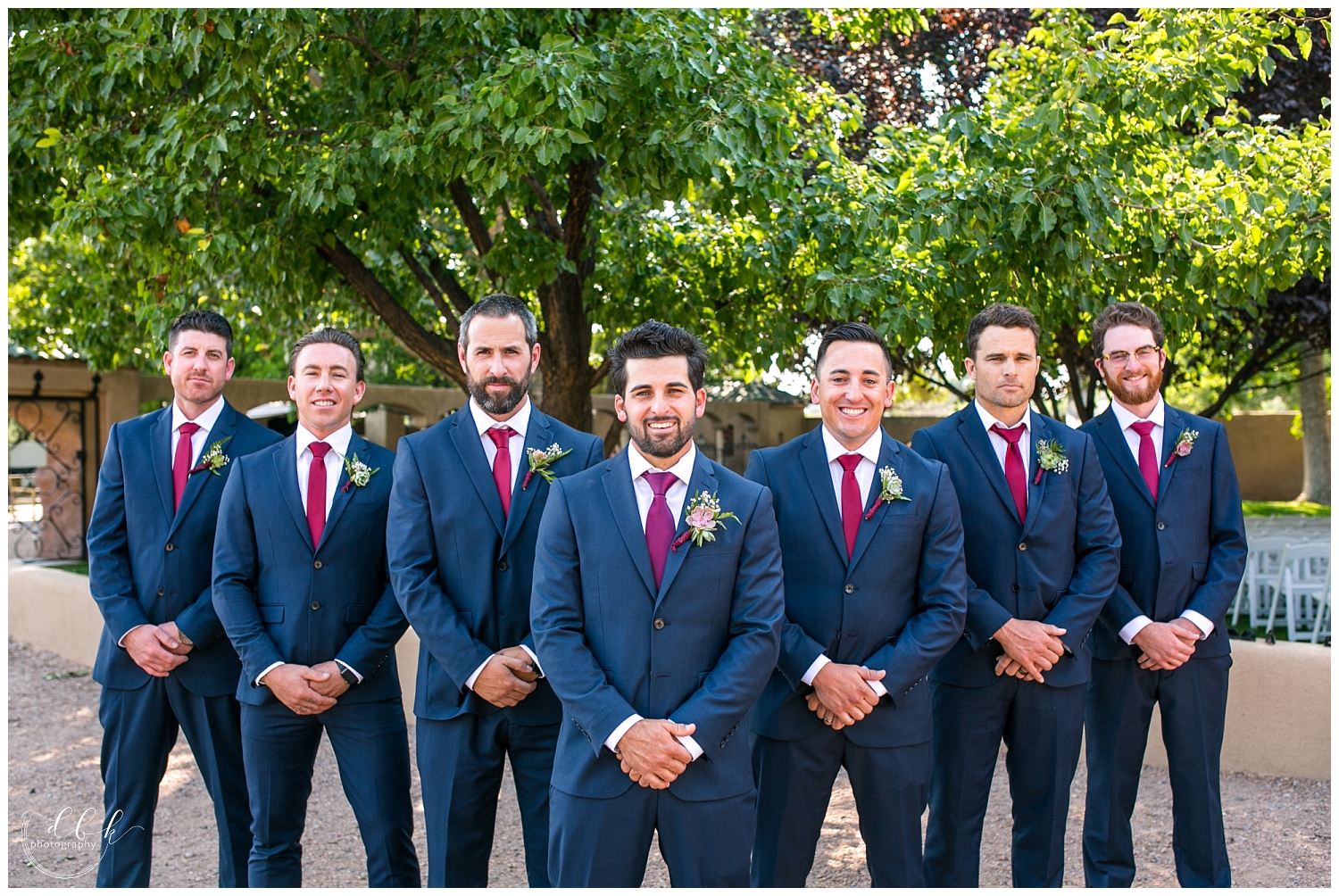 groomsmen in blue suits and maroon ties