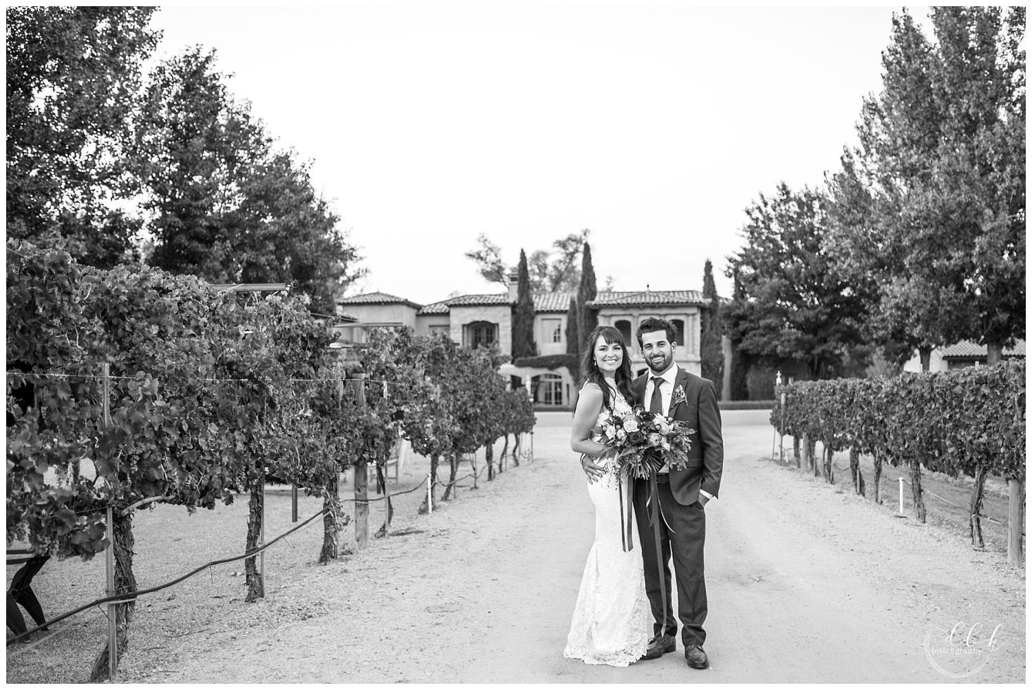 black and white portrait of bride and groom in front of Casa Rondena Winery