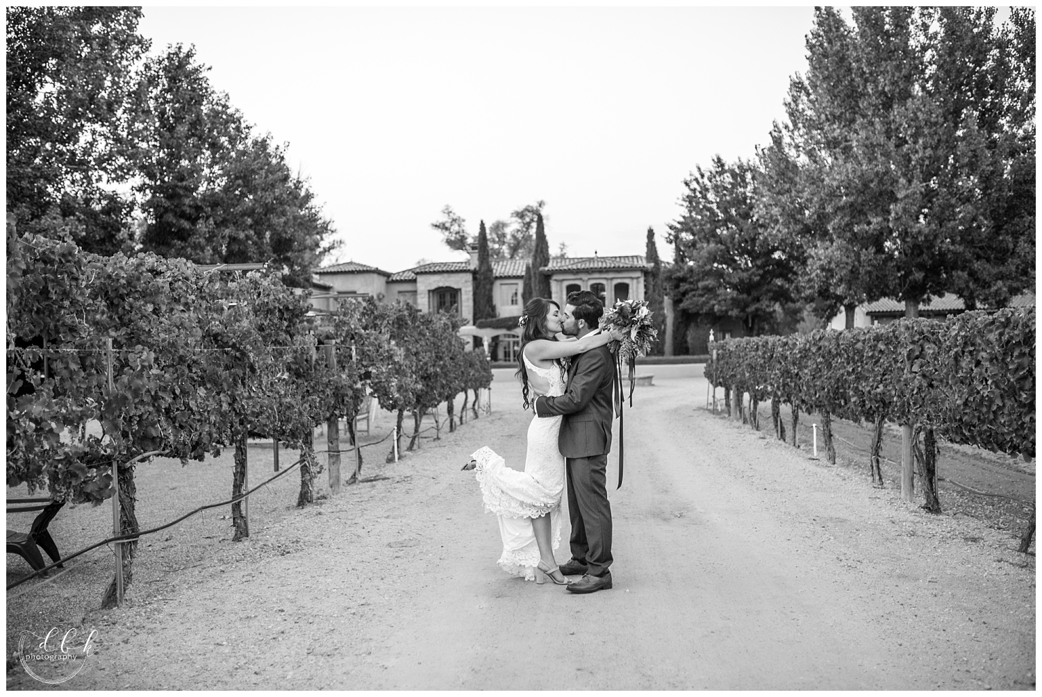 bride popping foot kissing groom in driveway at Casa Rondena Winery