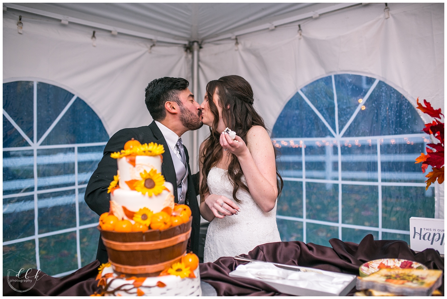 bride and groom share first bites of their fall-themed wedding cake at Filigree Farm