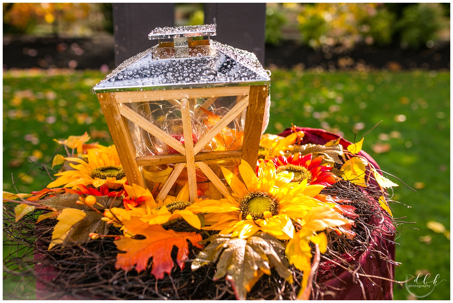 fall Filigree Farm wedding ceremony details: lanterns and orange leaves and flowers