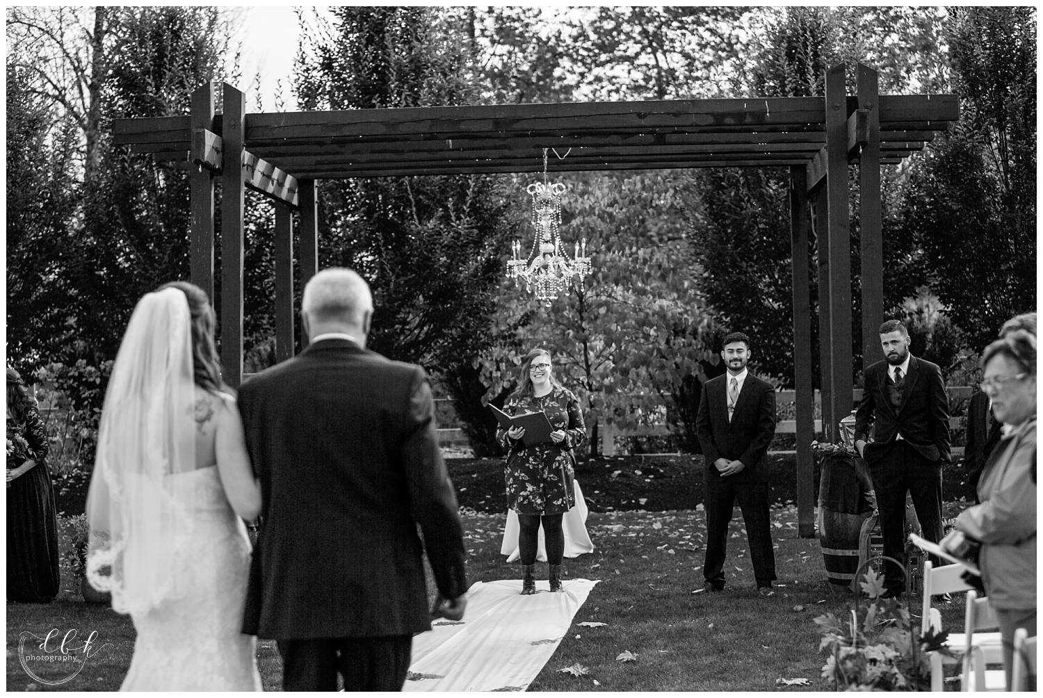 bride walks down the aisle with her father at fall wedding ceremony at Filigree Farm in Buckley, Washington
