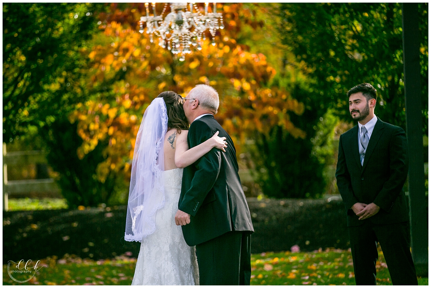 bride hugs her father at fall wedding ceremony at Filigree Farm in Buckley, Washington