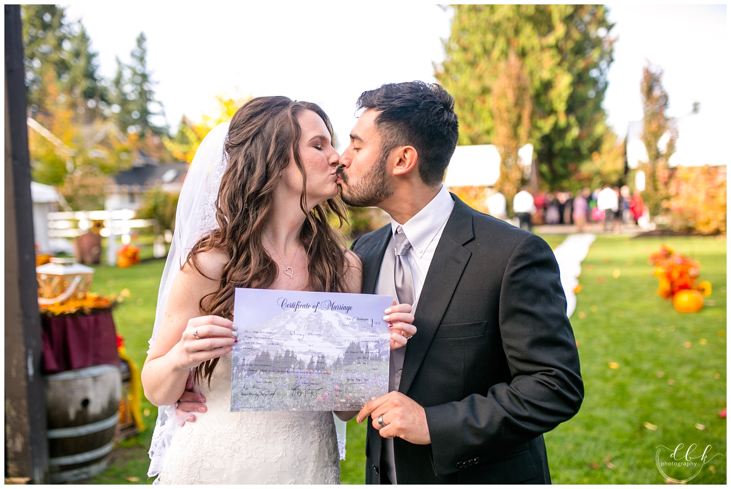 bride and groom with marriage license at fall Filigree Farm wedding