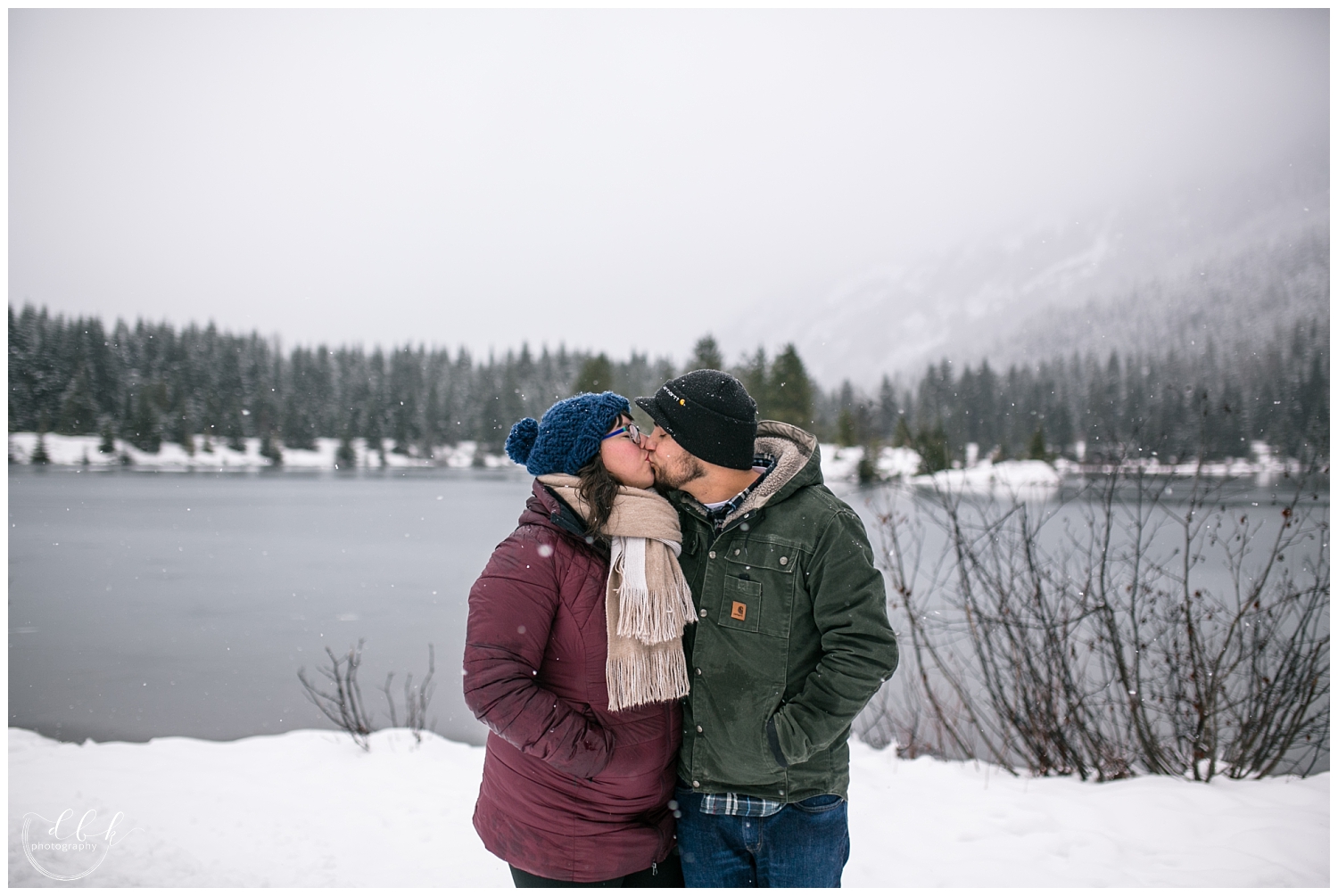 parents kissing during family portrait session at Gold Creek Pond, Washington