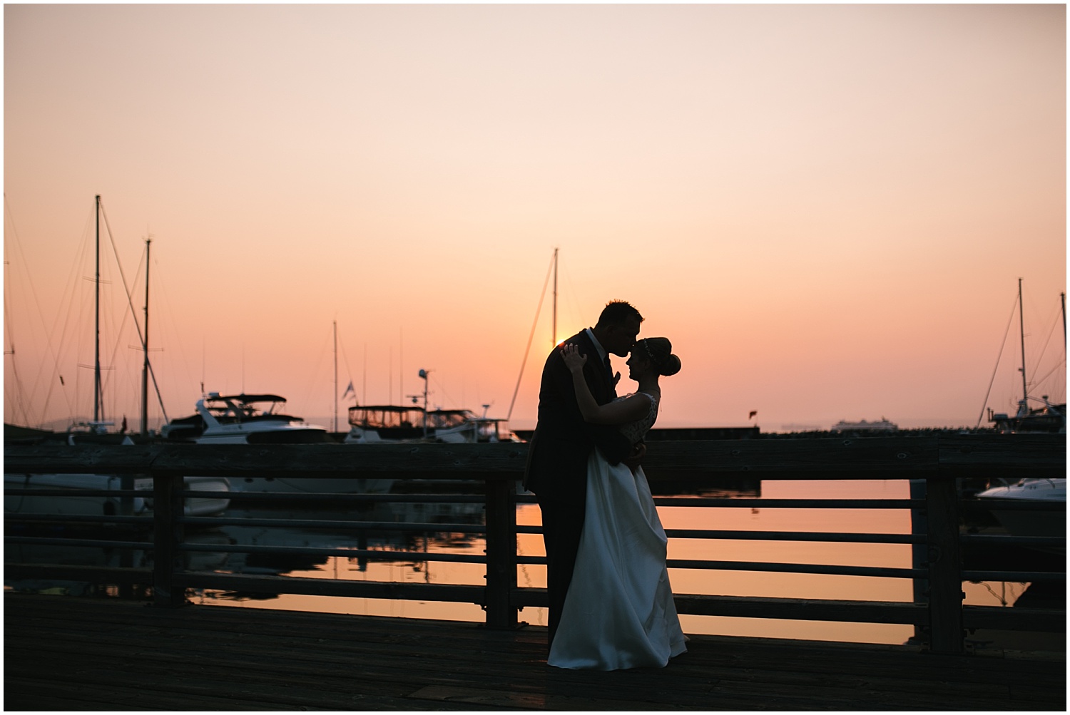 Bride and groom silhouette sunset portraits on the dock at Edmonds Yacht Club wedding