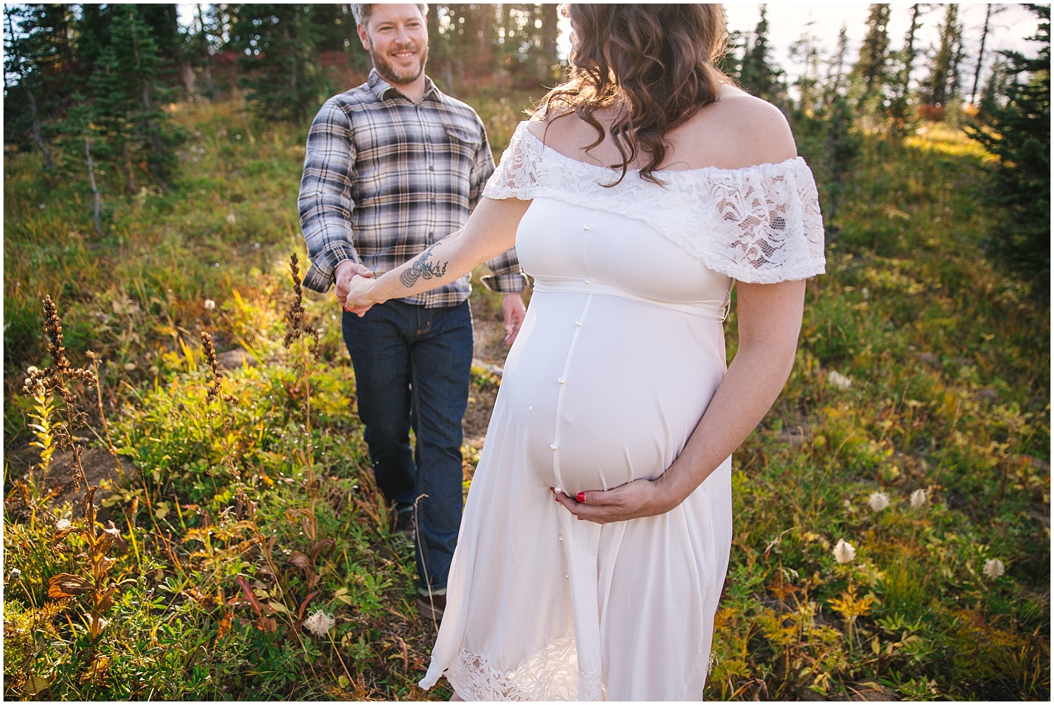 Couple walking together for fall maternity pictures at Mount Rainier National Park