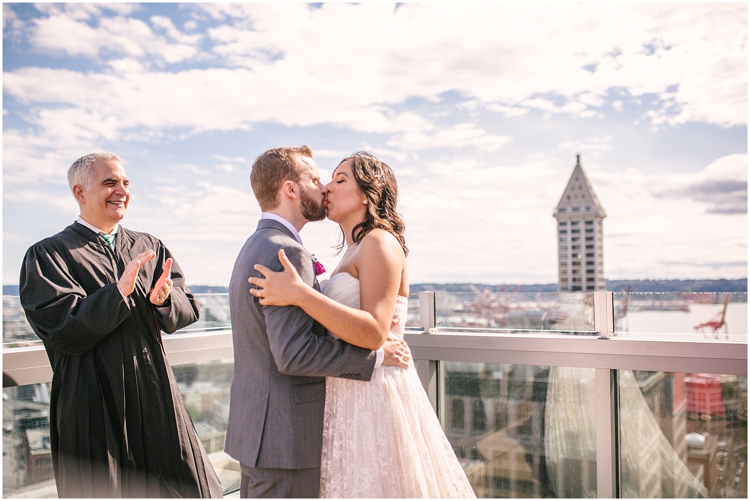 Bride and groom's first kiss at Seattle Municipal Court wedding ceremony on the rooftop.