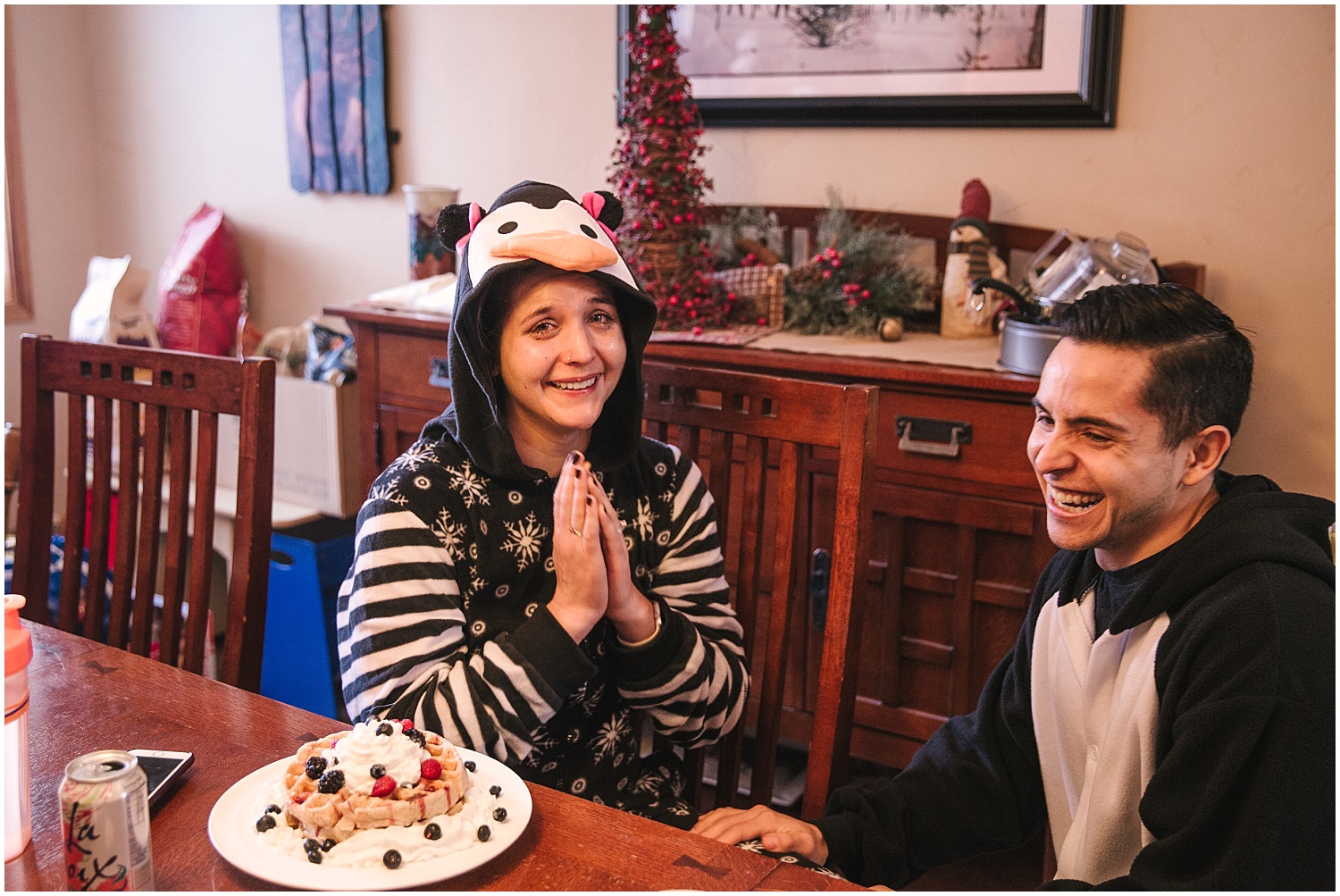 Couple wearing matching penguin onesies for surprise proposal at Winter Park, Colorado