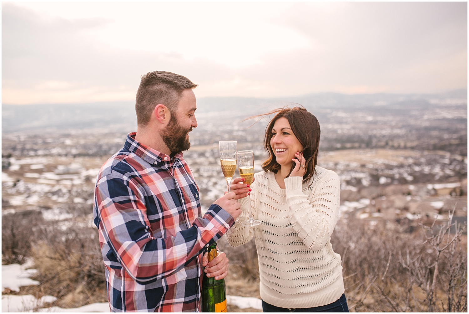 Popping champagne for Castle Rock Colorado engagement photos.