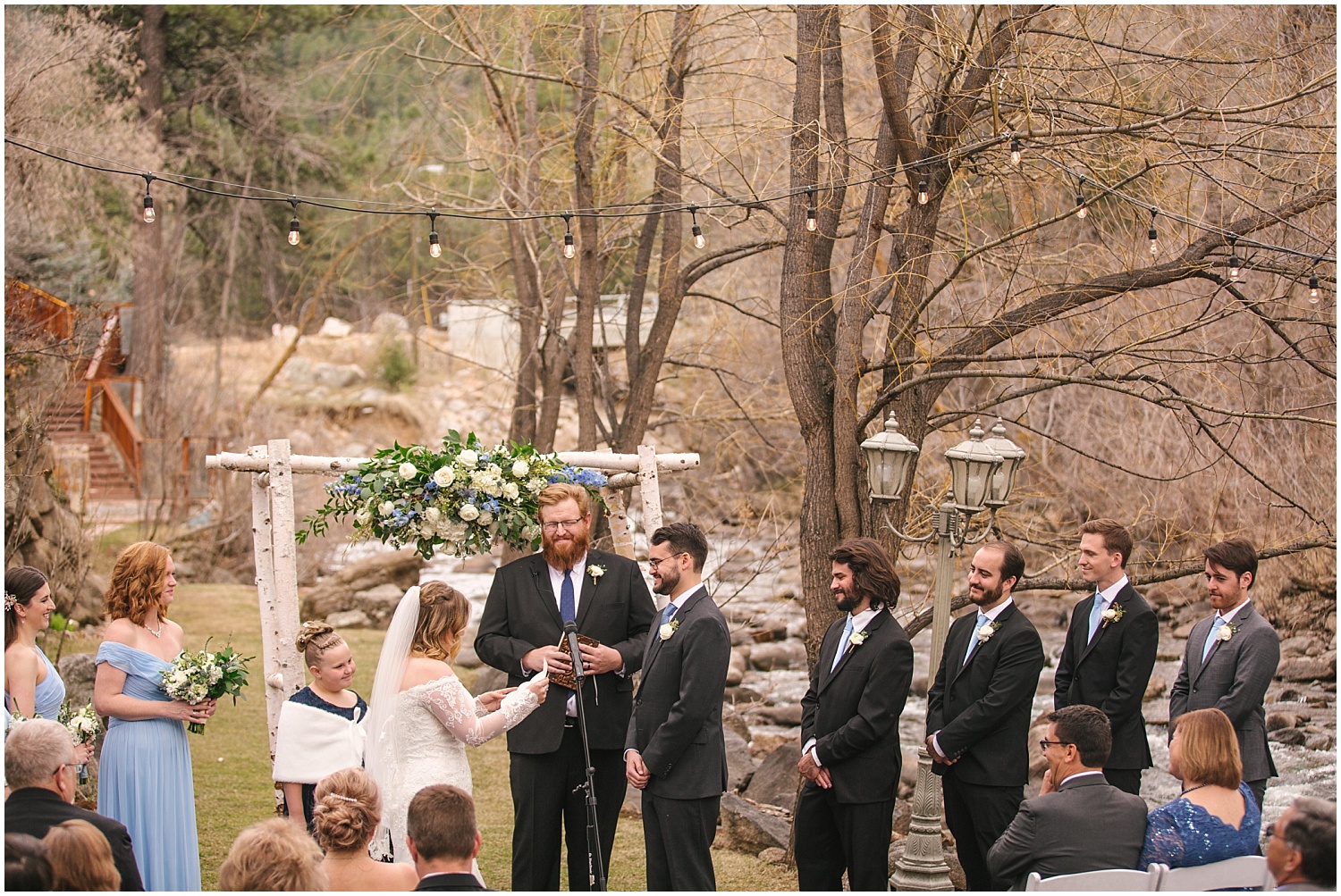 Bride and groom say their vows at wedding ceremony by the creek at Wedgewood Weddings Boulder Creek wedding venue