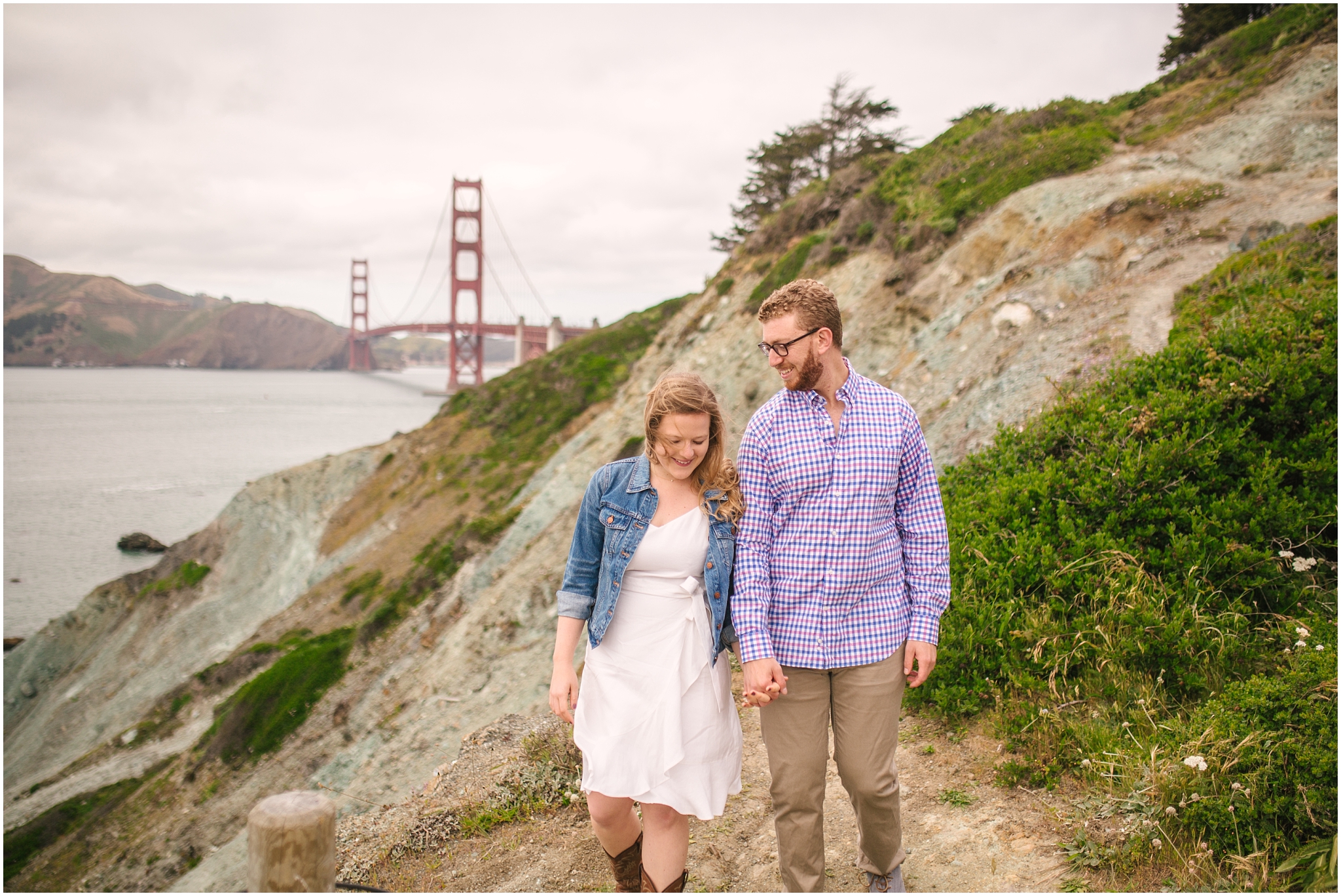 Couple walking in front of Golden Gate Bridge for San Francisco engagement pictures