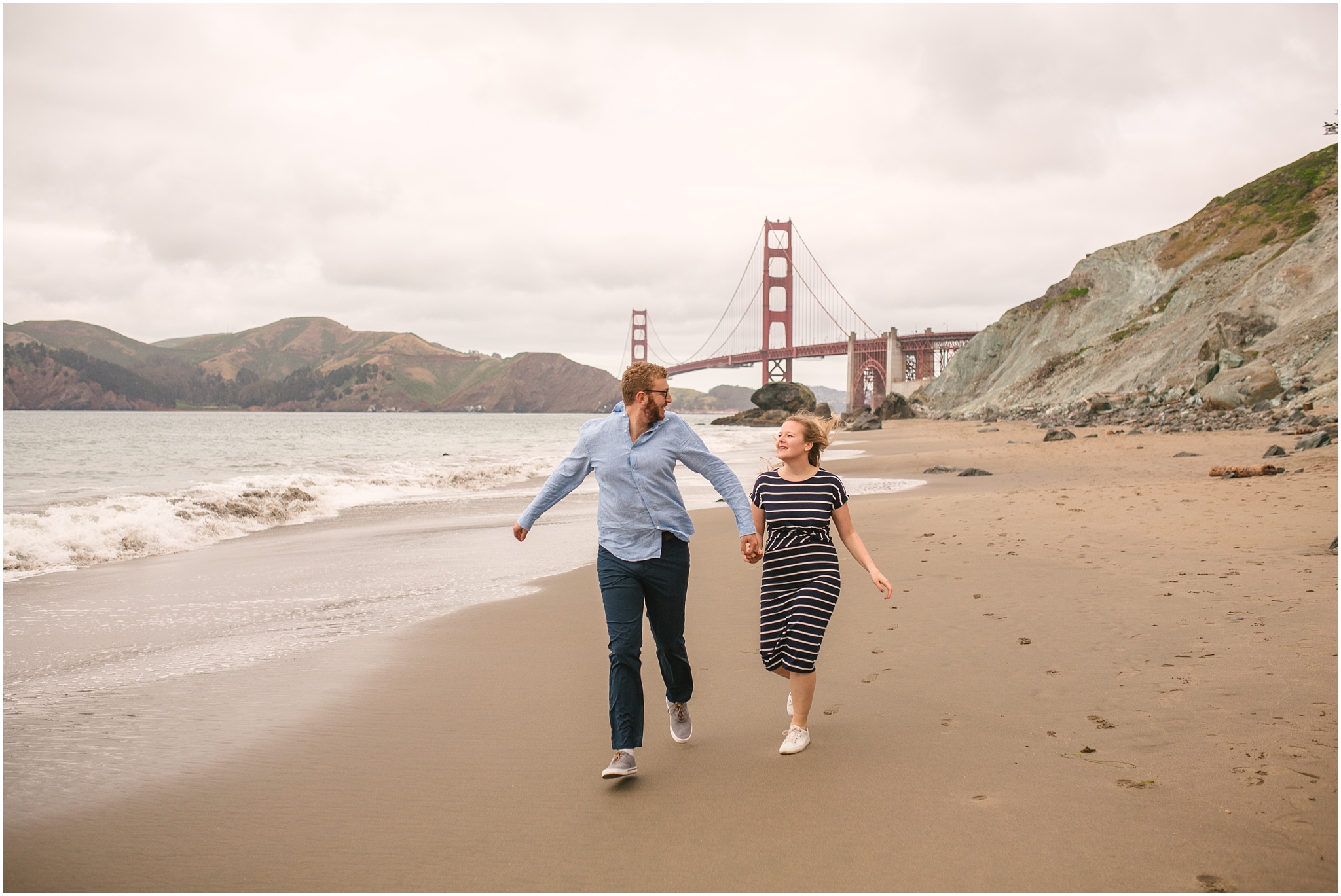 Couple running on the beach - Marshall Beach San Francisco engagement pictures