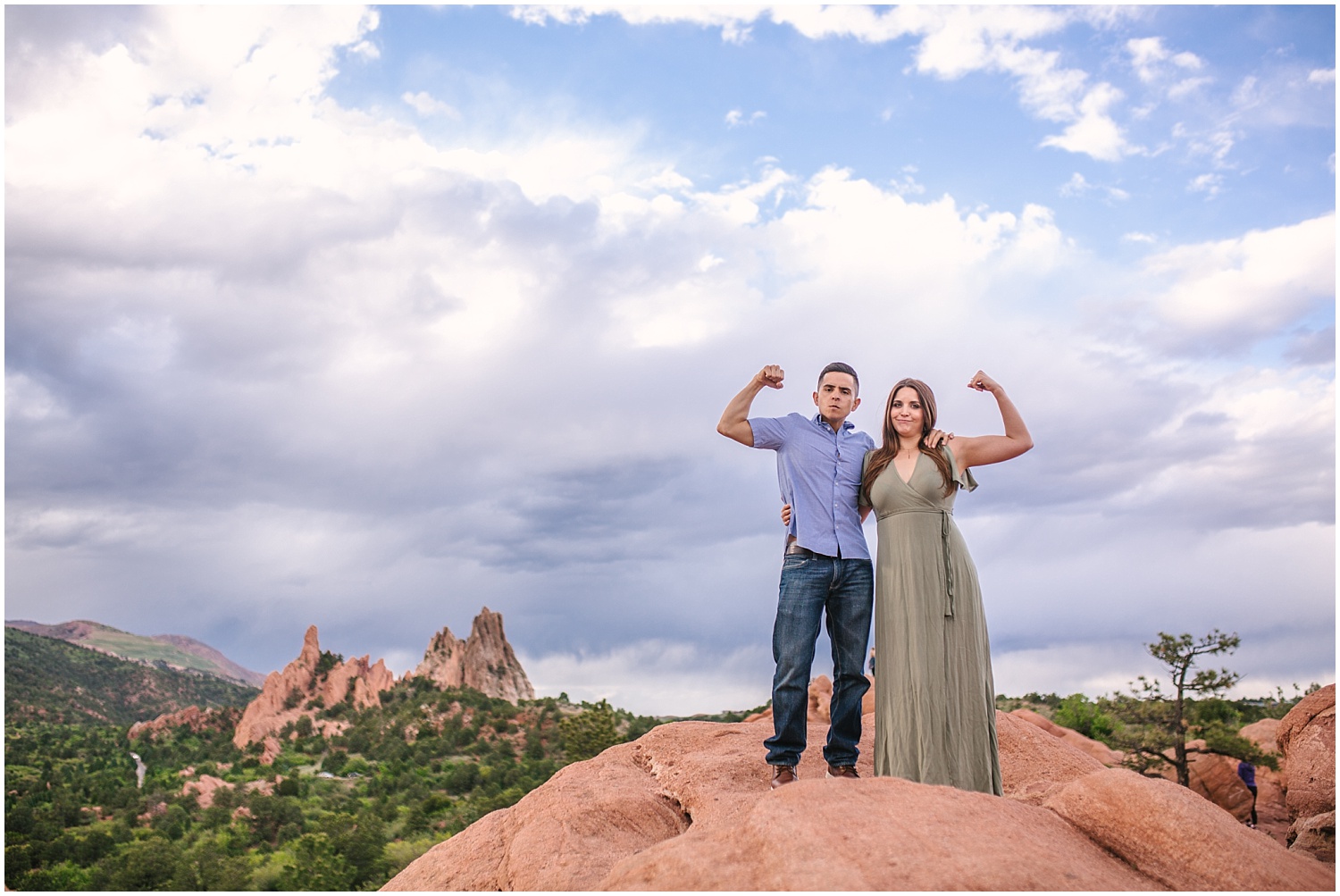 Couple showing off muscles on red rocks at Garden of the Gods in Colorado Springs