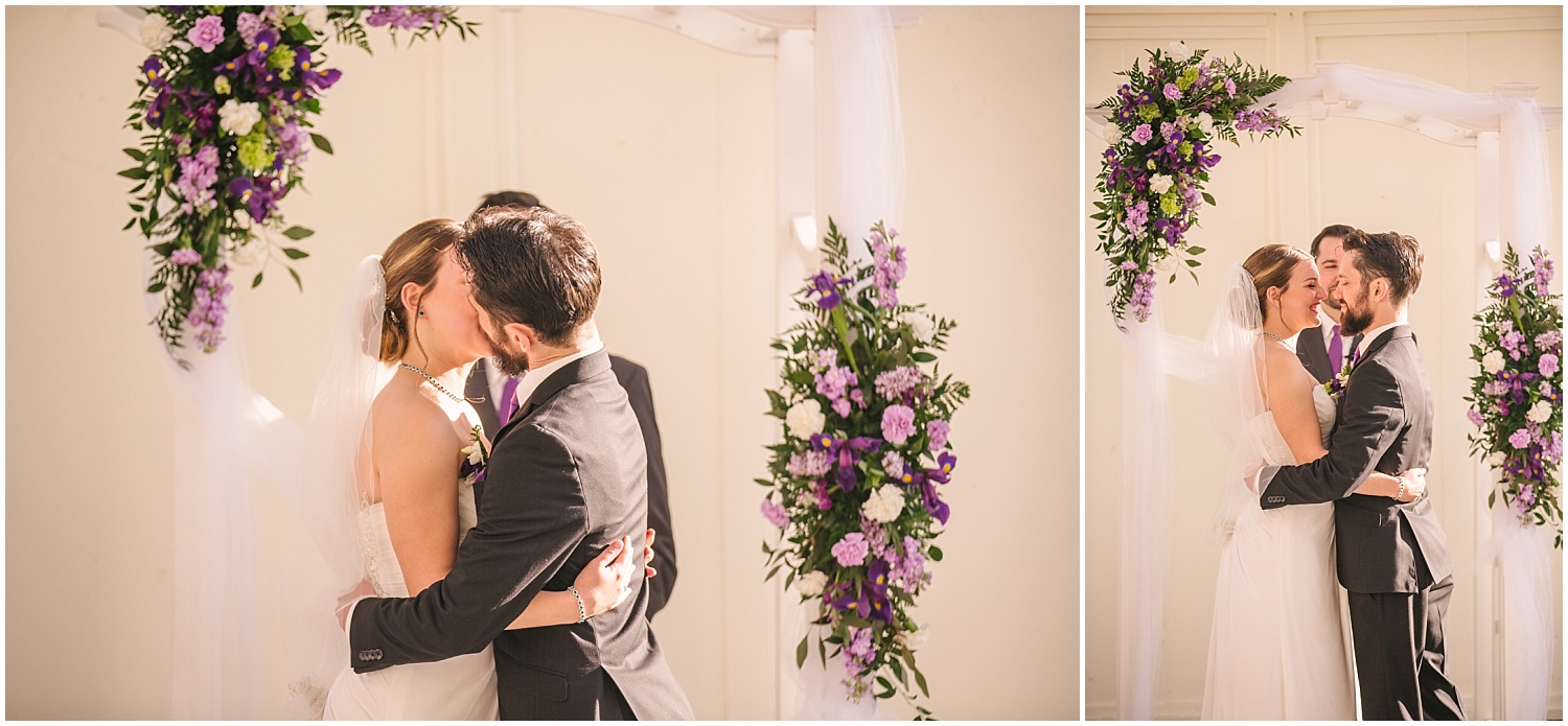 Bride and groom's first kiss at Jefferson Street Mansion wedding 