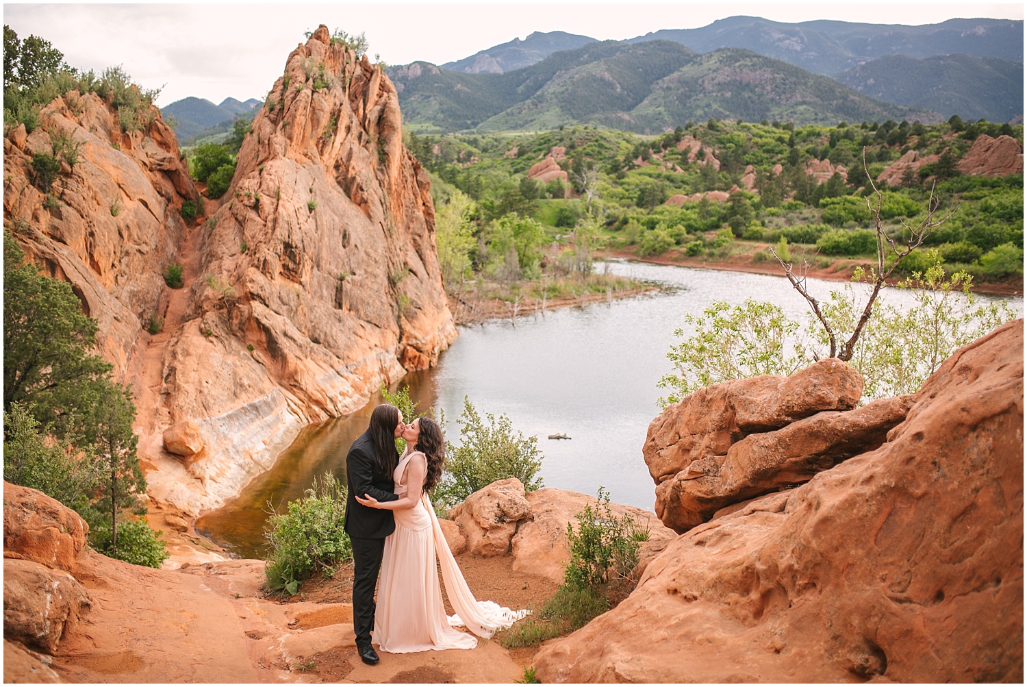 Couple kissing at water overlook for Red Rock Canyon Open Space engagement photos in Colorado Springs