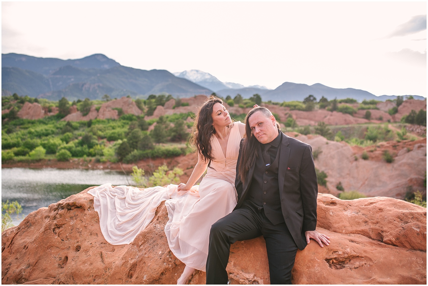 Bride and groom sitting on overlook at Red Rock Canyon Open Space
