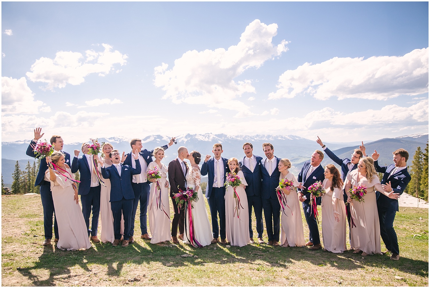 Light pink bridesmaid dresses and dark navy suits for the groomsmen at Keystone Colorado wedding