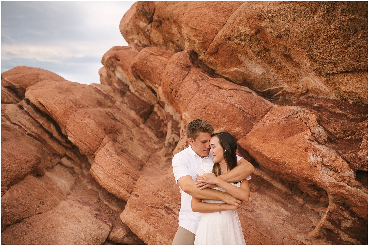 Couple embracing among the red rocks at Garden of the Gods for Colorado Springs engagement pictures