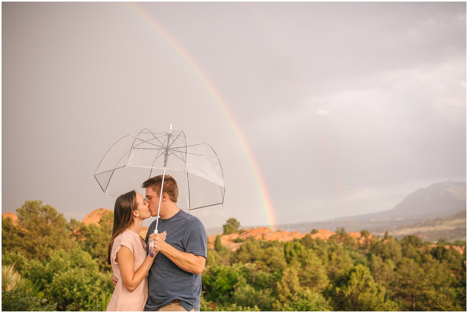 Double rainbow over couple with umbrella at Garden of the Gods in Colorado Springs