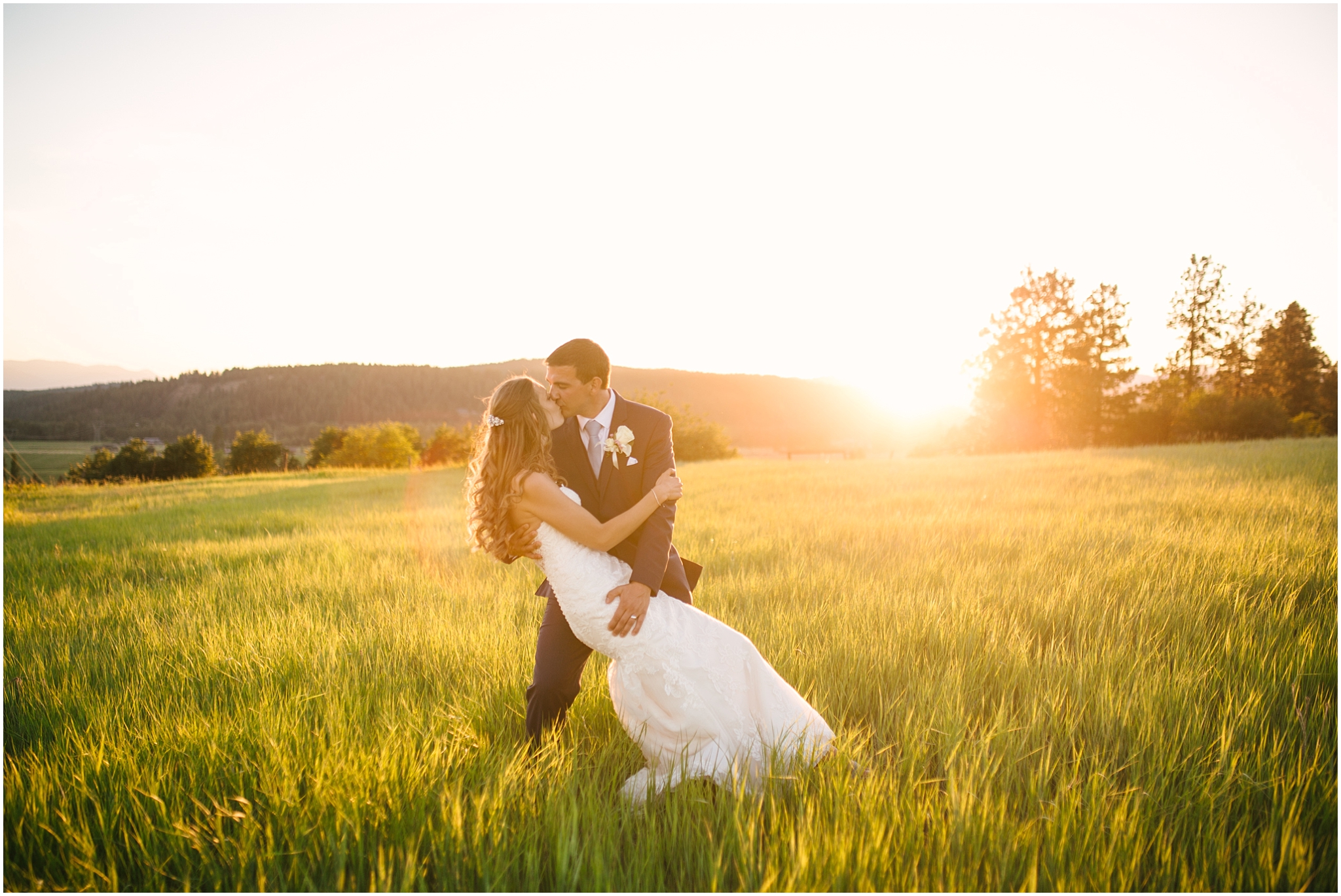 Bride and groom kissing in a field at golden hour at Cle Elum wedding