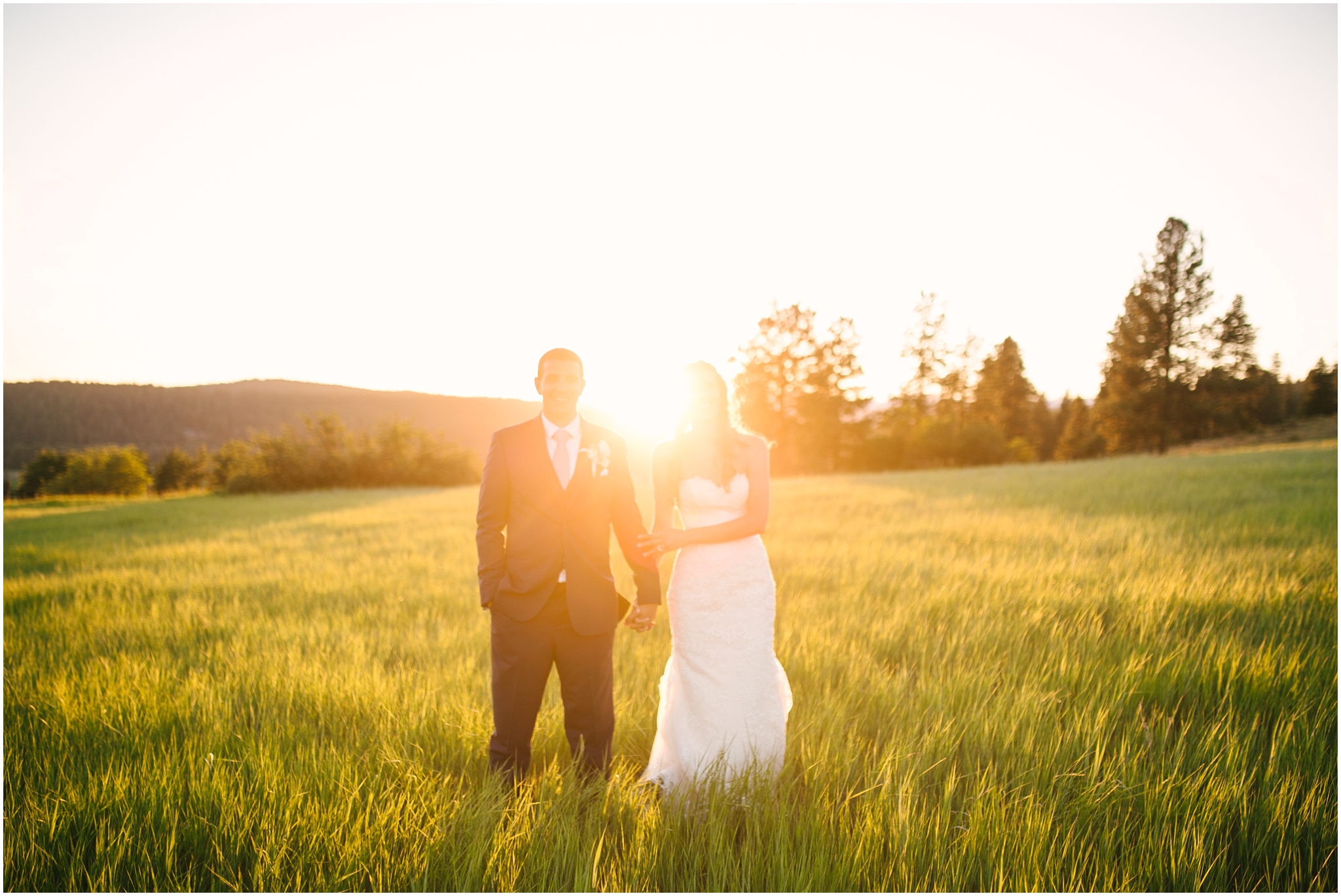 Bride and groom standing in a field at golden hour at Cle Elum wedding
