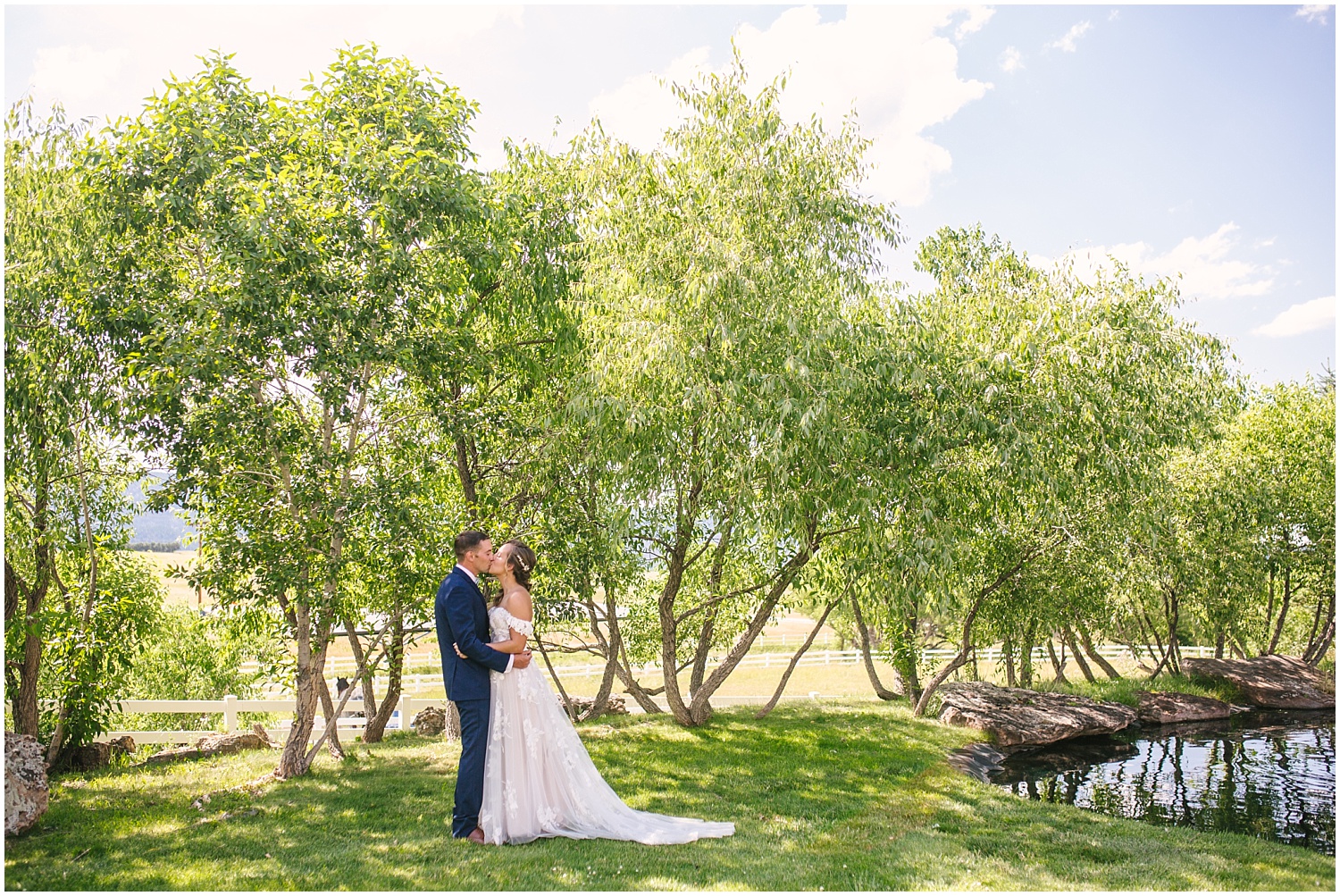 Bride and groom kissing by the trees at Crooked Willow Farms wedding