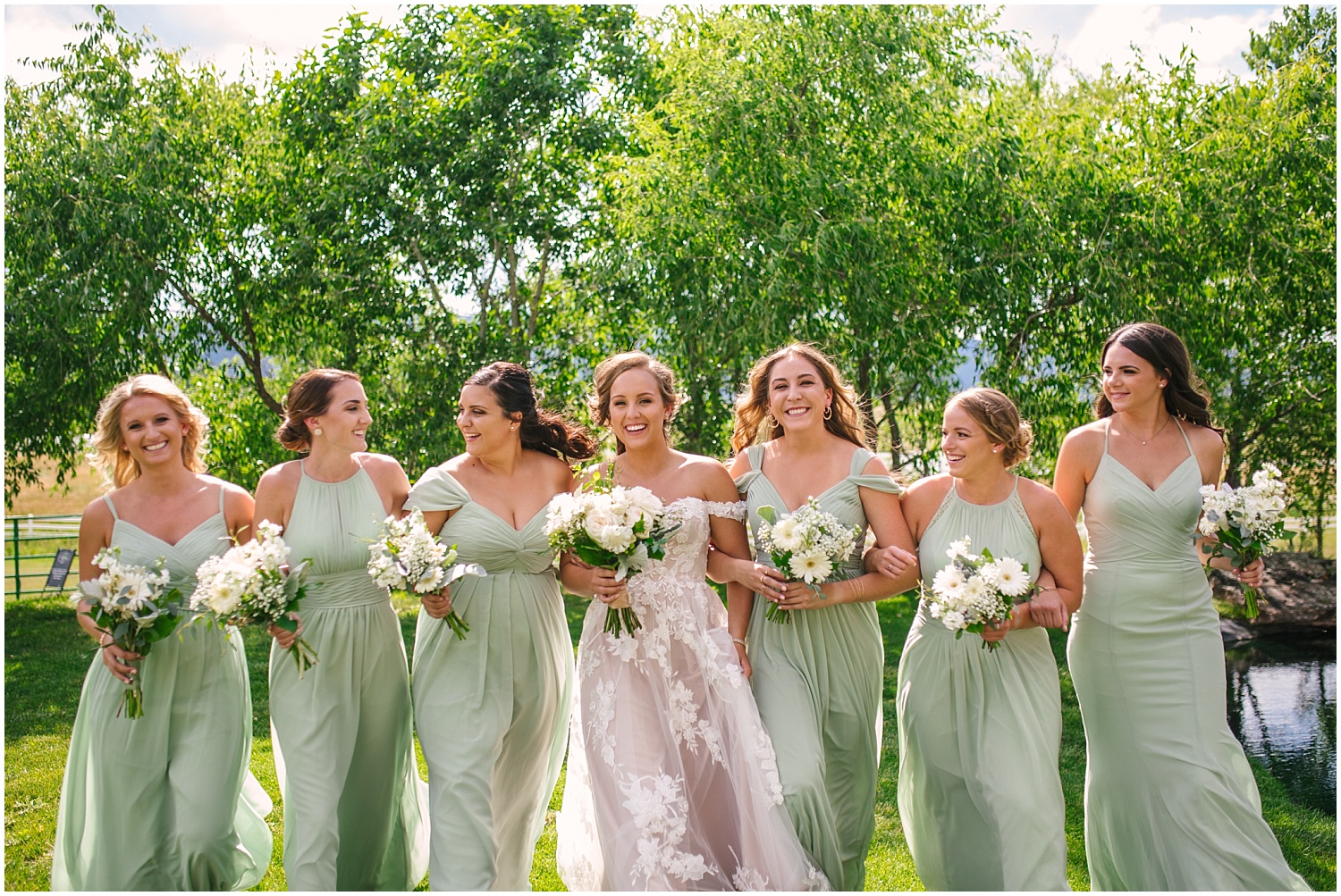 Bridesmaids in sage green dresses with white peony bouquets at Crooked Willow Farms wedding
