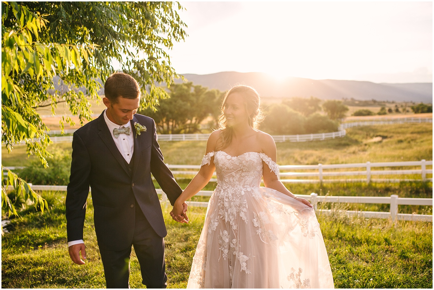 Bride and groom walking through fields at Crooked Willow Farms at golden hour