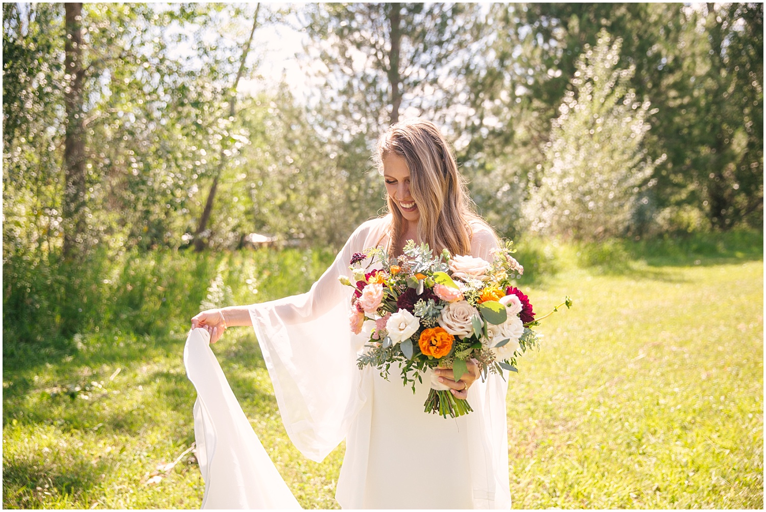 Bride with long-sleeved wedding dress by Shareen Bridal and bouquet by Fawns Leap at Lone Hawk Farm in Longmont Colorado