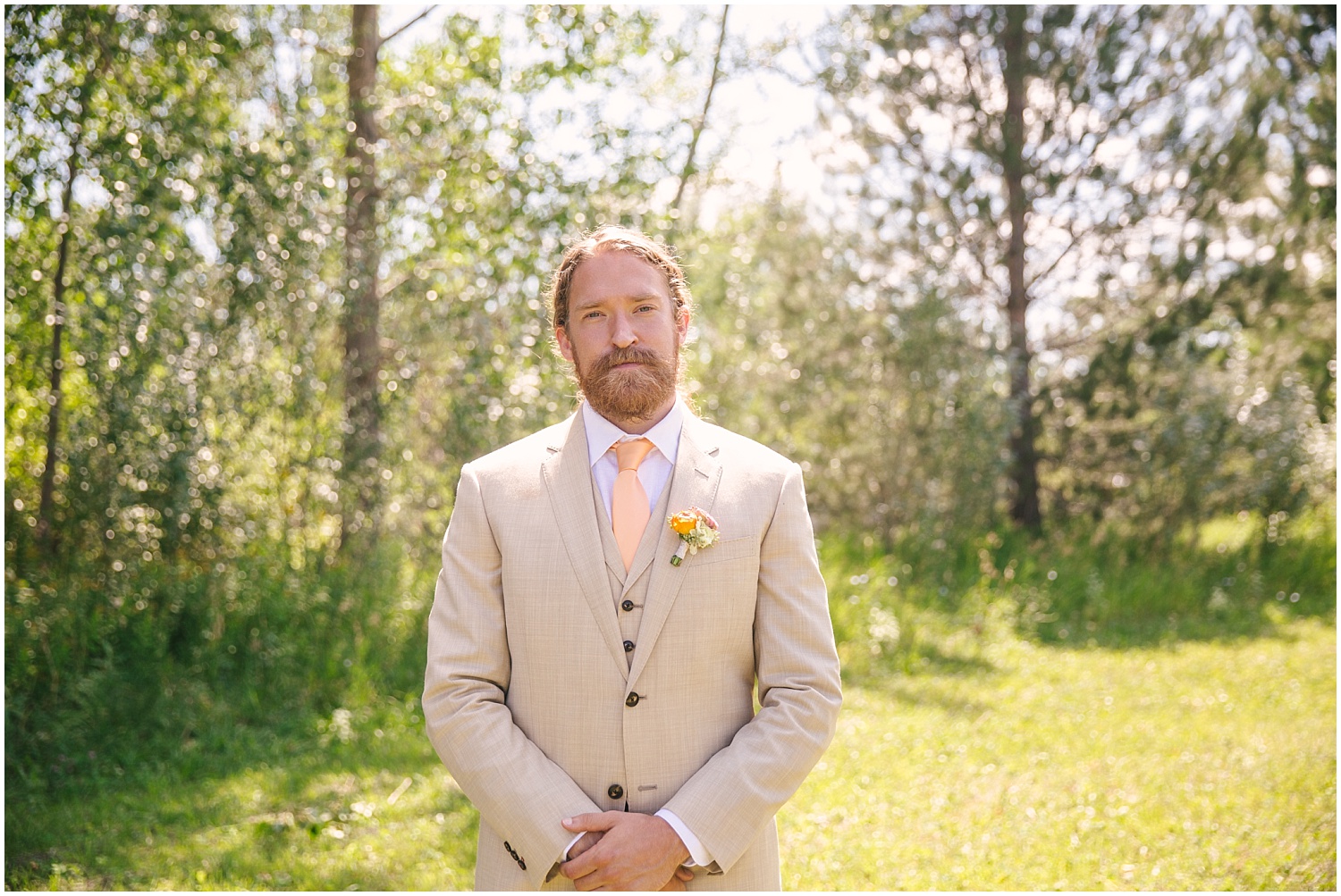 Groom in custom taupe suit by The Bespoke Edge at Lone Hawk Farm in Longmont Colorado