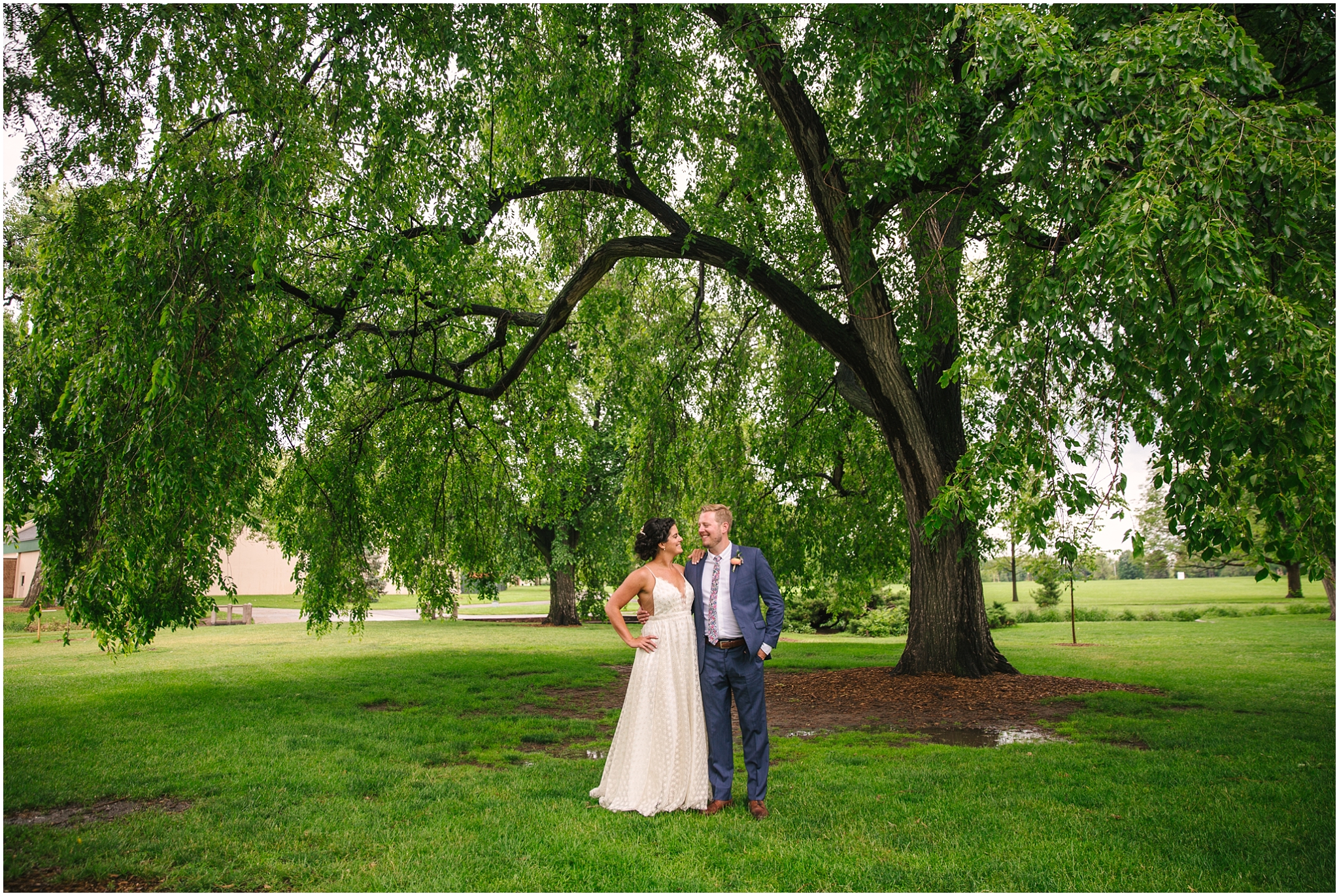 Bride and groom under a willow tree at Washington Park Boathouse wedding in Denver Colorado