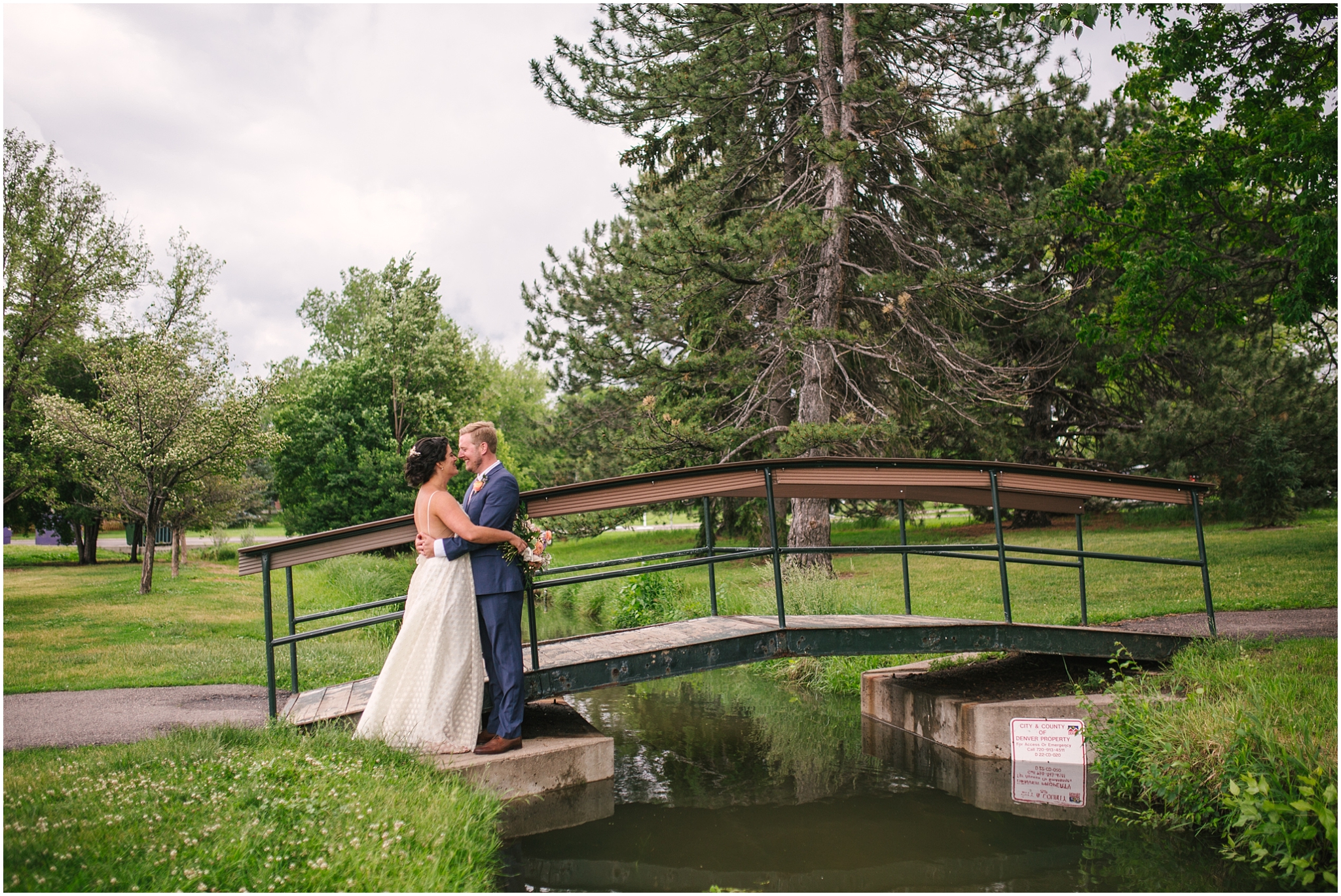 Bride and groom on a foot bridge at Washington Park in Denver Colorado