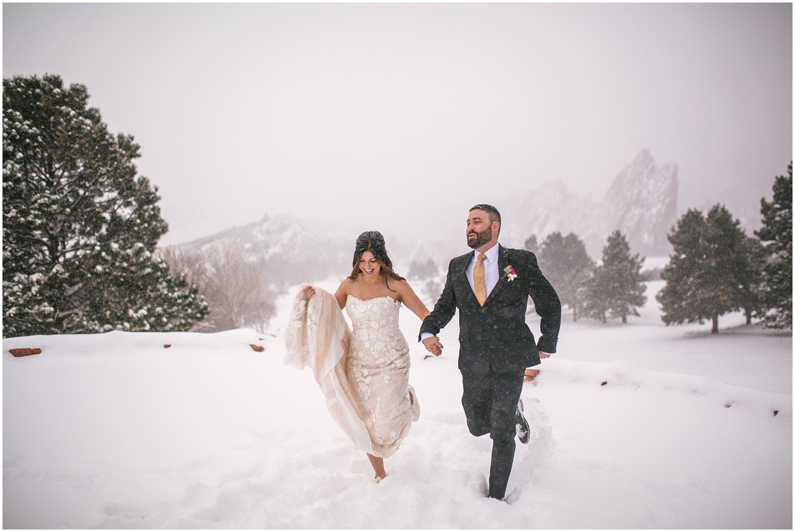 Bride and groom running through the snow together at Arrowhead Golf Club winter wedding