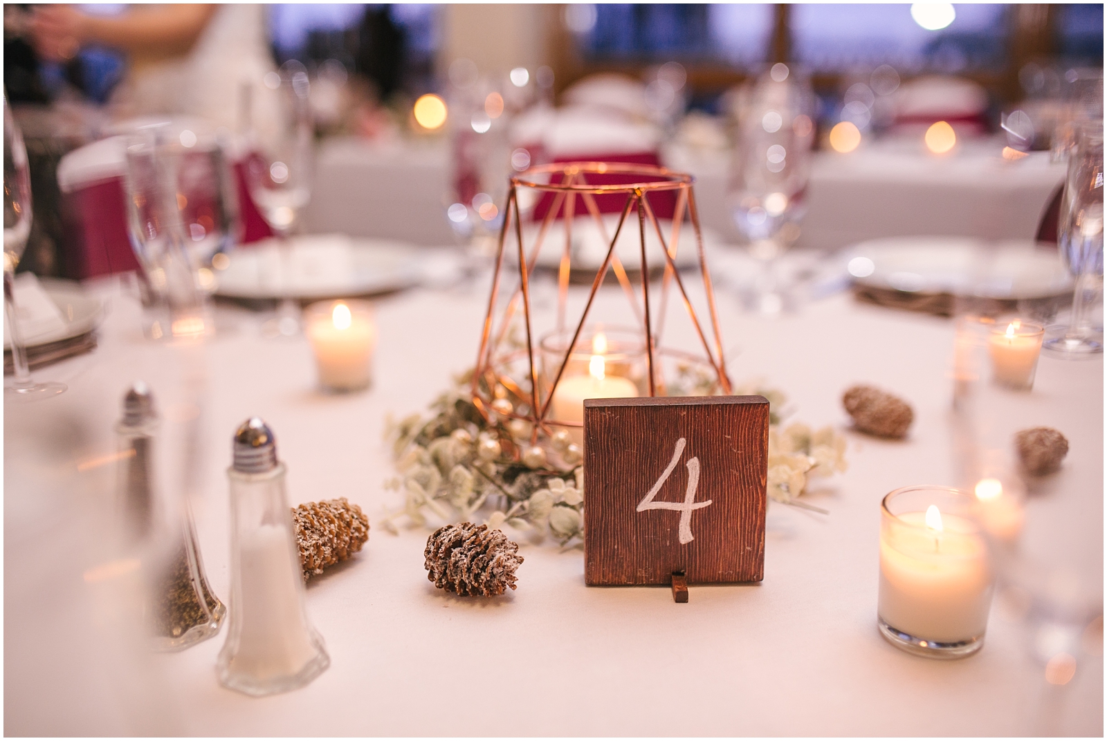 Pine cones and candles as winter wedding details at Arrowhead Golf Club