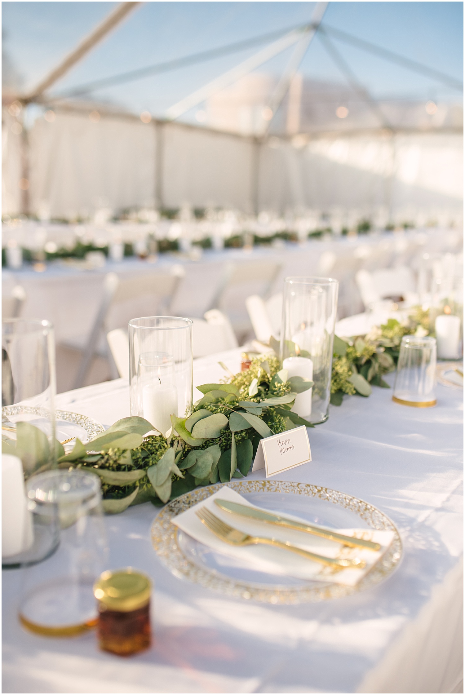 Eucalyptus, white candles, and gold lined dinnerware at backyard wedding in NE Albuquerque Acres