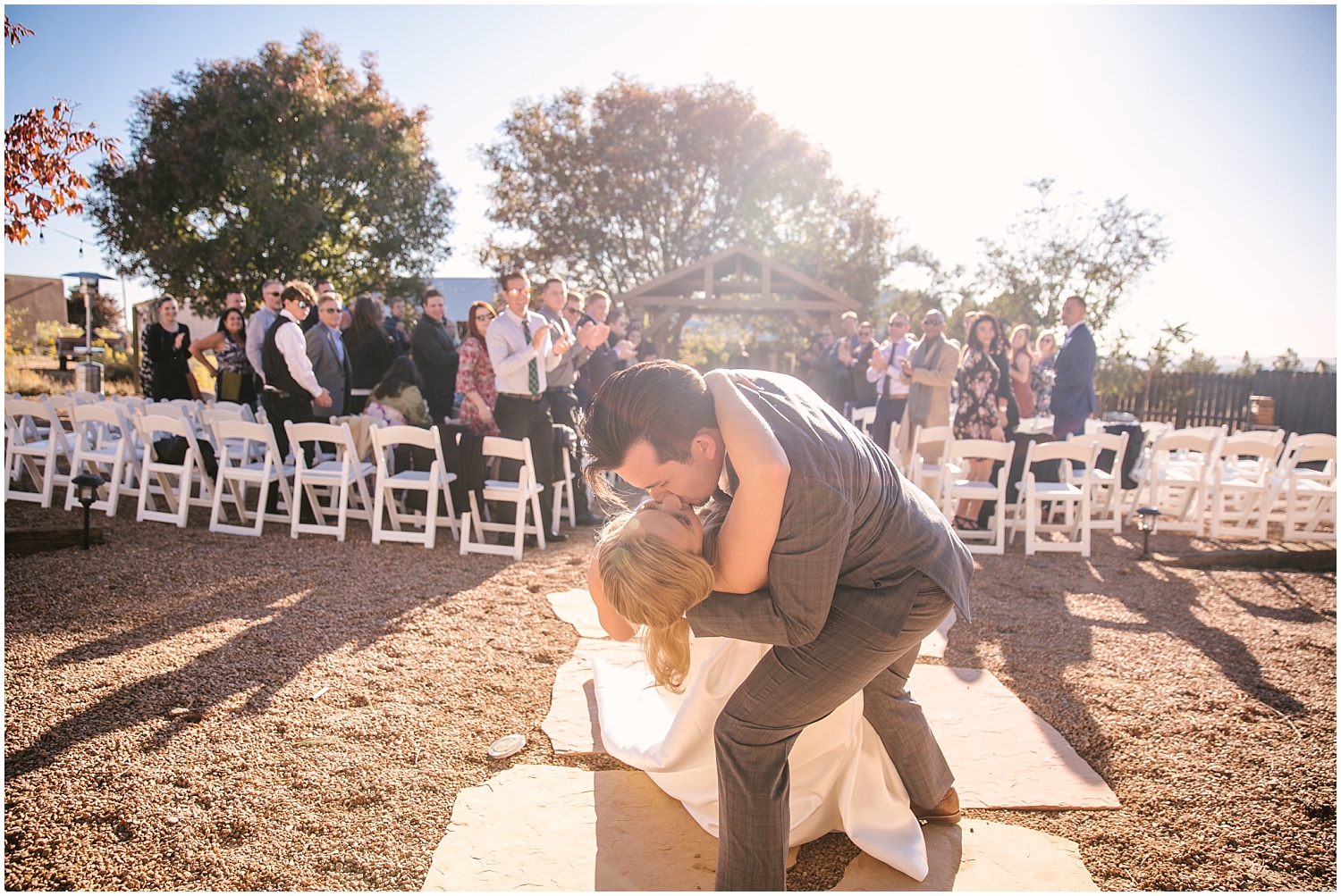 Bride and groom's first kiss at backyard wedding ceremony in northeast Albuquerque Acres New Mexico