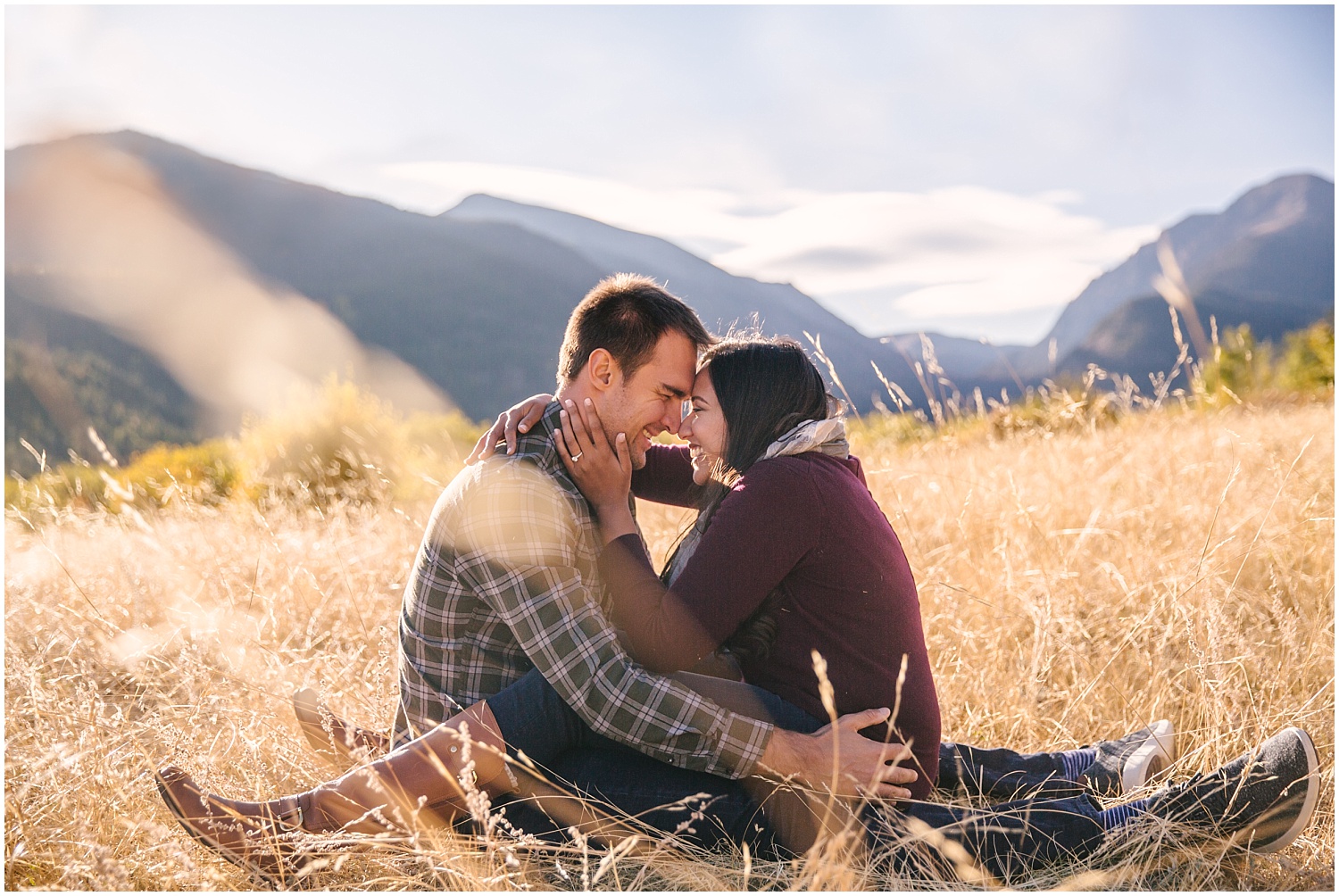 Couple cuddling in a field at Endovalley in Rocky Mountain National Park